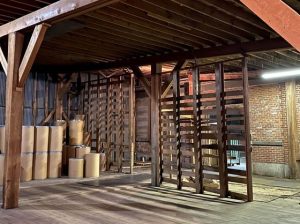 warehouse area with empty shipping barrels at The Master Package Fibre Shipping Containers
