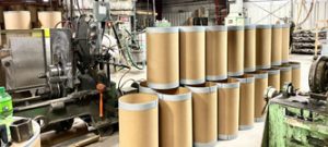 small photo of finished fibre containers near manufacturing equipment at The Master Package Fibre Shipping Containers