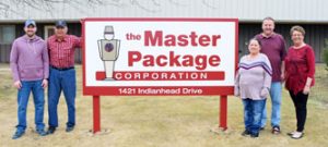 small team photo of staff standing near their logo sign outside facility The Master Package Fibre Shipping Containers