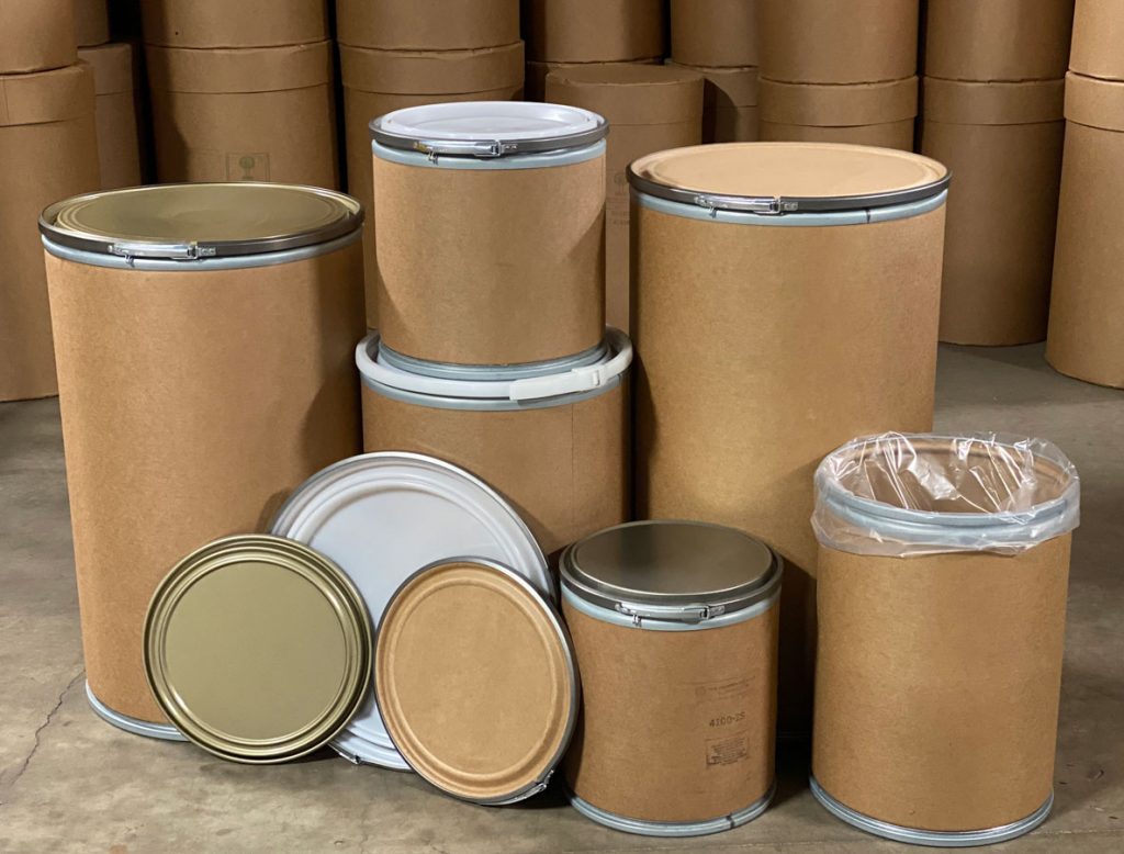 display in warehouse of 6 different sizes of fibre barrels and steel locks at The Master Package Fibre Shipping Containers