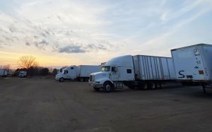 transportation trucks loading up fibre barrels at sunrise in Wisconsin The Master Package Fibre Shipping Containers