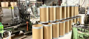 close up of finished fibre drum barrels near manufacturing machines at The Master Package Fibre Shipping Containers